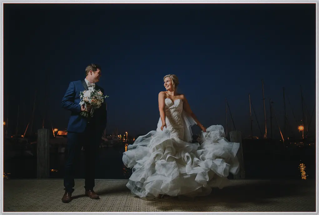 Hannah swings her ruffled skirt as Matt laughs beside her on the dark Hillarys marina deck