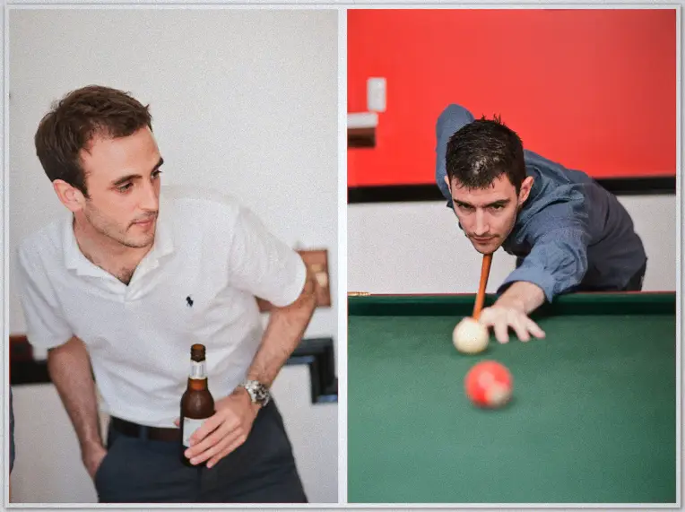 Wedding Photographer Groomsmen unwind over a pool table at the winery, one raising a beer and another lining up a shot