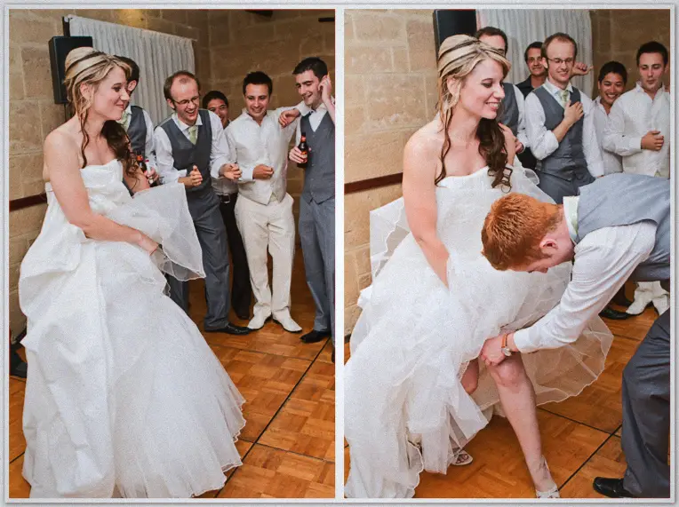 Groomsmen crowd a laughing Lauren before one stoops to retrieve the garter from beneath her gown