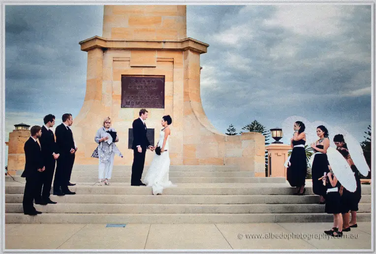 Fremantle Wedding | Charlene and Phil Charlene and Phil exchange vows on the memorial steps beneath a brooding sky with parasol bridesmaids