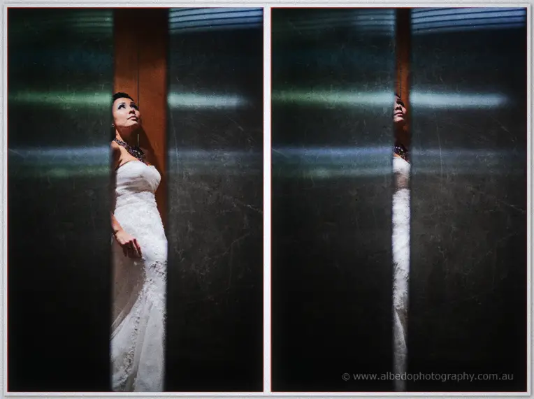 Fremantle Wedding | Charlene and Phil Charlene in her strapless gown gazes upward through a narrow gap between dark elevator doors