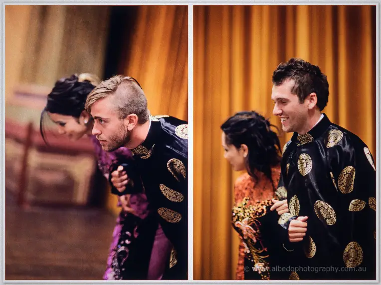 Fremantle Wedding | Charlene and Phil Men in black gold-embroidered silk robes bow playfully during the tea ceremony, Charlene laughing behind them