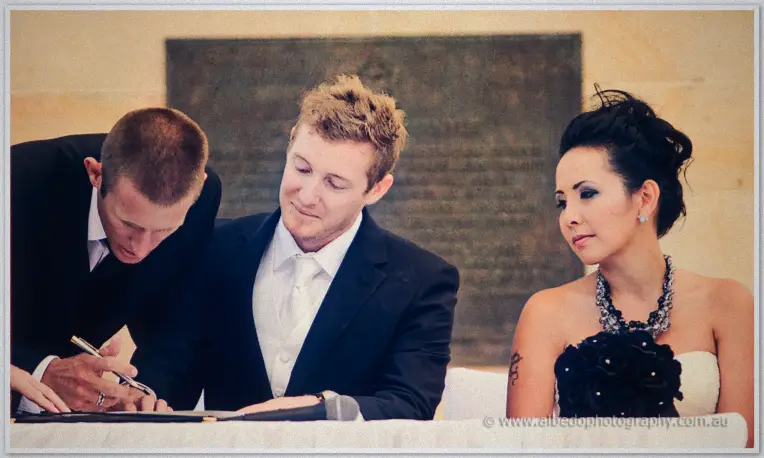 Fremantle Wedding | Charlene and Phil The best man signs the register as Phil and Charlene lean in beside the memorial plaque
