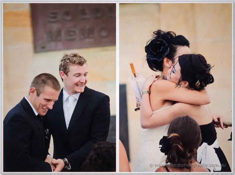 Fremantle Wedding | Charlene and Phil Phil grins beside his groomsman before Charlene embraces a friend beneath the memorial plaque