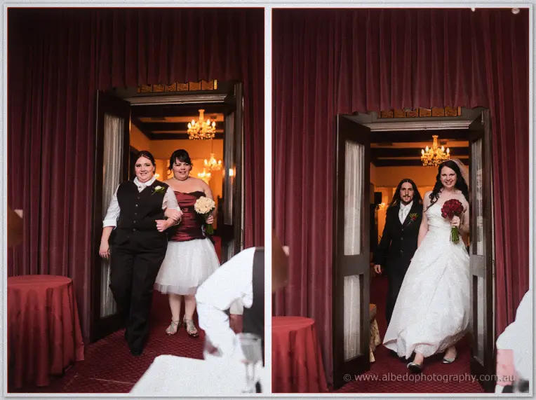 After her bridesmaids walk through, Jenn enters on her escort's arm beneath the glowing chandelier