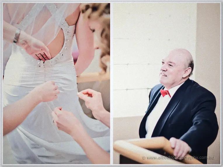 Hands fasten the beaded back of Emily's gown beside a portrait of her smiling father in a red bow tie