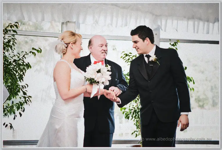 Emily's father joins her and Quentin's hands beneath the white marquee canopy