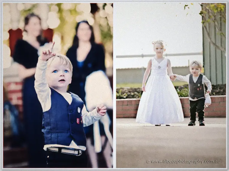 A little page boy points skyward, then walks hand in hand with the flower girl outside