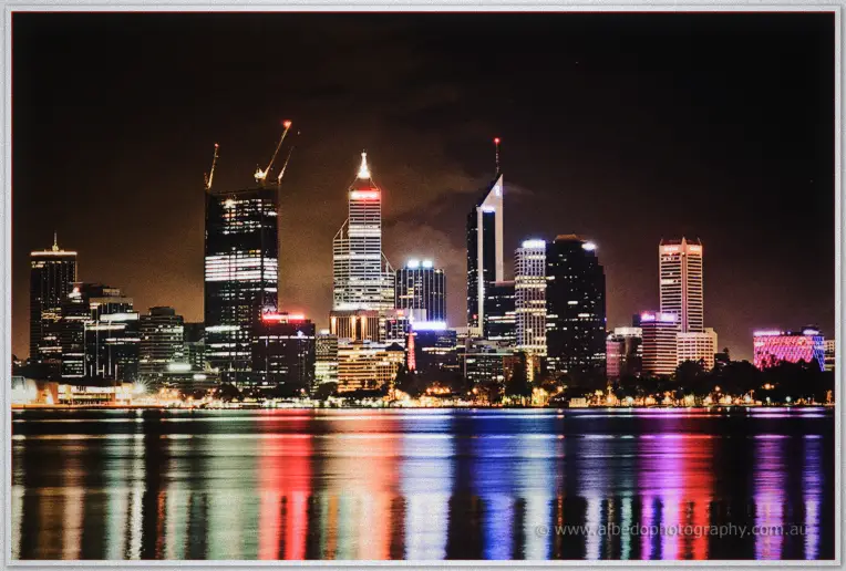 Perth's city lights shimmer across the Swan River in a long-exposure night scene