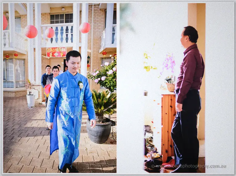 Khoa in his blue ao dai walks past red lanterns to Michelle's home, where a relative greets his party.
