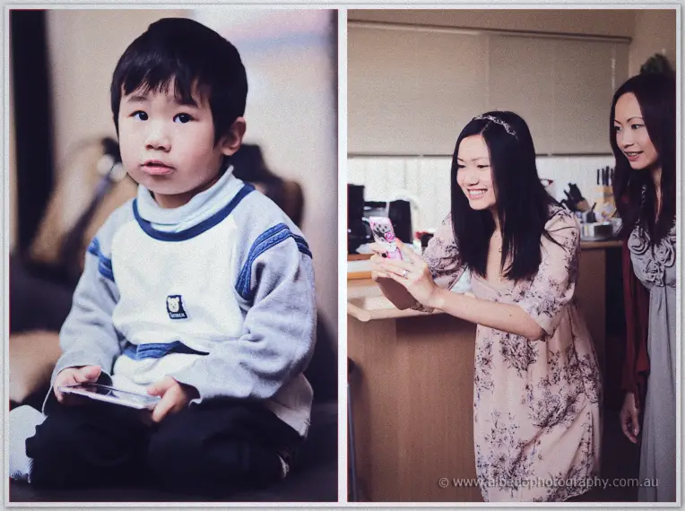 A young page boy clutches a phone on the couch while Michelle checks messages in the kitchen nearby.