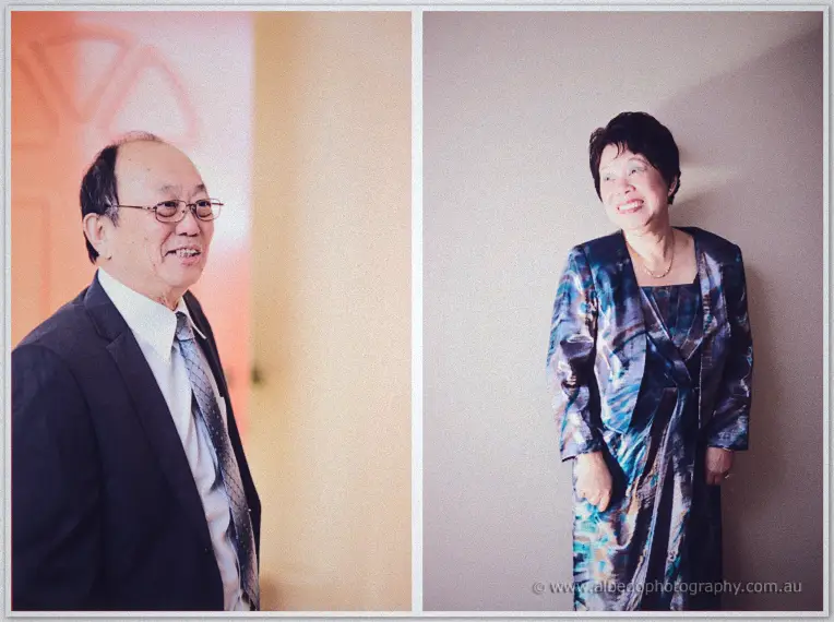 Michelle's parents pose in their finest, her father suited and her mother in a shimmering blue dress.