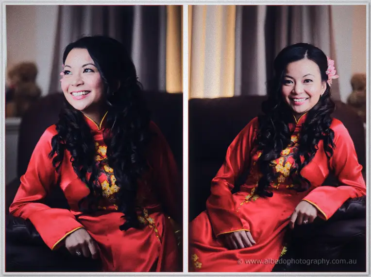 Bride Michelle beams in an embroidered red silk ao dai for her portraits before the tea ceremony.