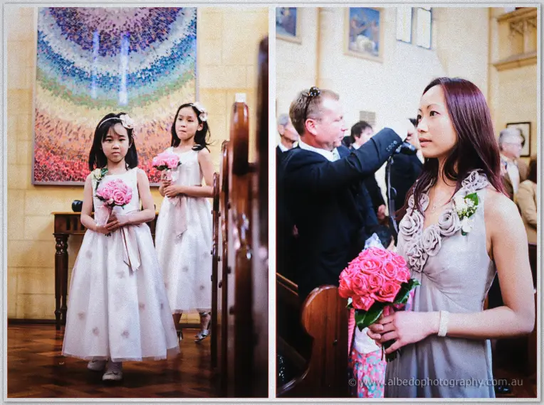 Flower girls wait by a colourful mosaic as a red-haired bridesmaid holds her pink rose bouquet nearby.