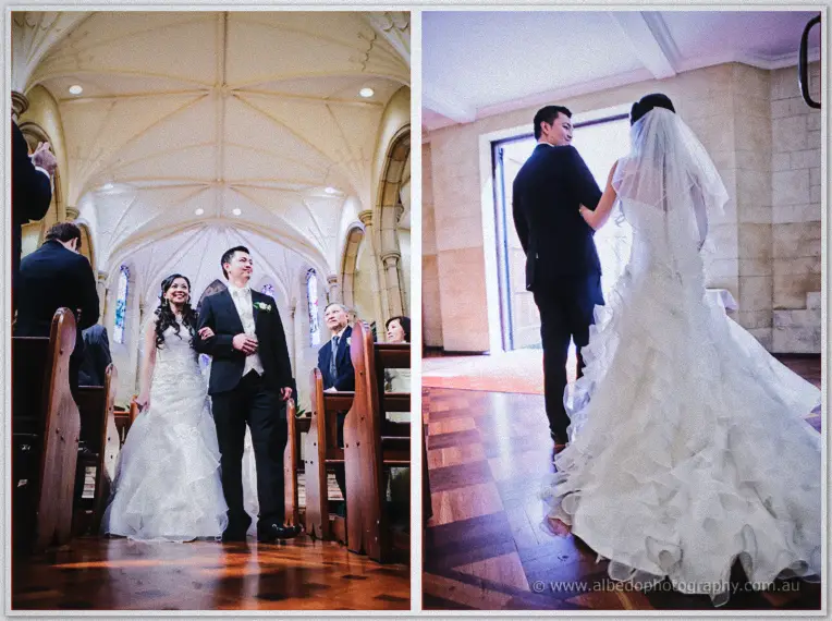 The couple grins down the aisle between guests, then strolls hand in hand toward the bright church doors.
