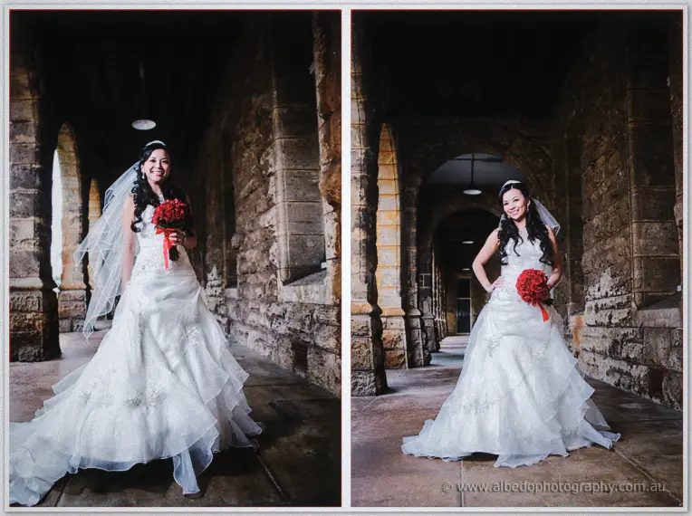 Michelle poses with her red bouquet under the stone arches, veil catching soft window light.