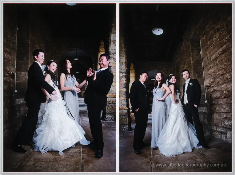Bridal party in grey and black share a laugh inside the sandstone colonnade.