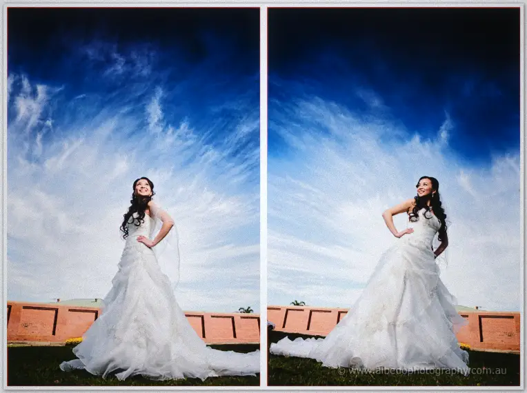 Michelle in red and Khoa in blue traditional dress stand together beneath brooding clouds.
