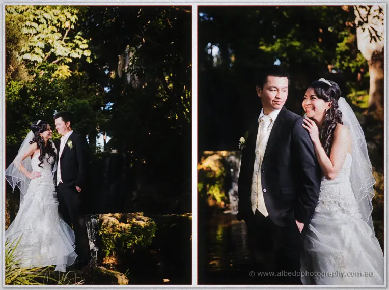 Bridesmaid and bride laugh on the grass as a gust lifts their skirts skyward.