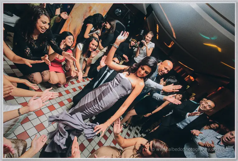 Arms reach in from every side as Lydia dances at the centre of the packed floor