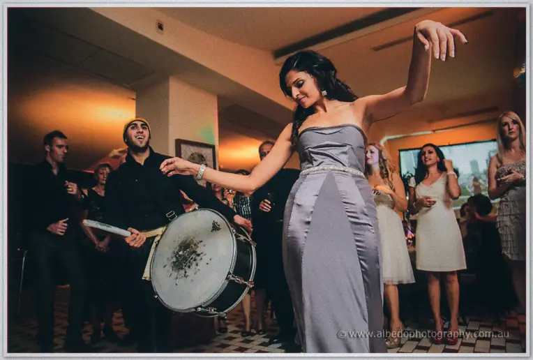 Lydia sways low with one arm flung out as the drummer pounds away behind her
