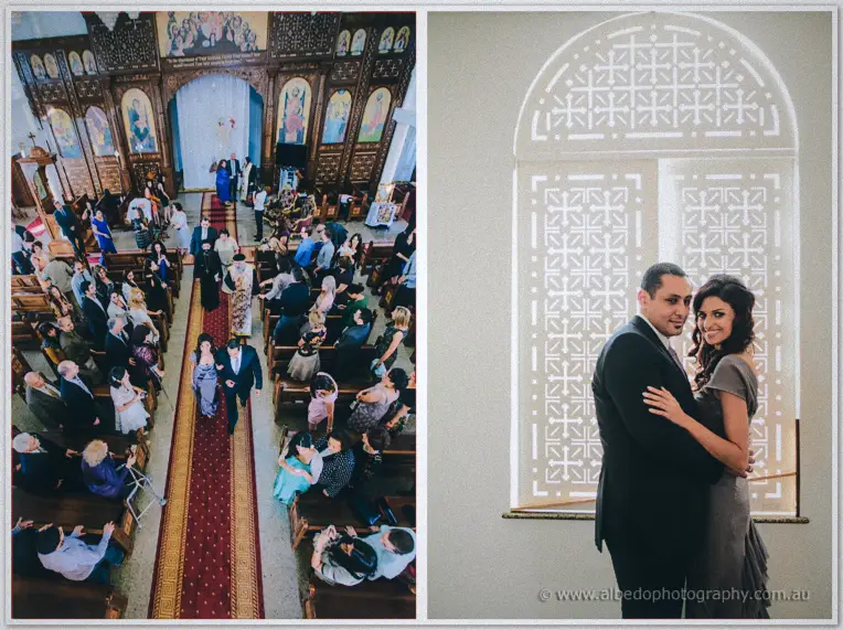 The couple walks the red-carpet aisle past guests, then embrace by a glowing lattice window