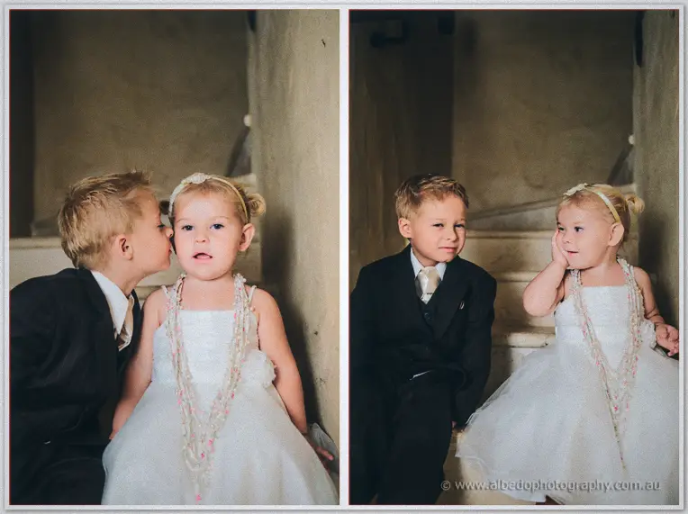 Diptych of the pageboy kissing the flower girl's cheek, then the pair seated on stone steps.