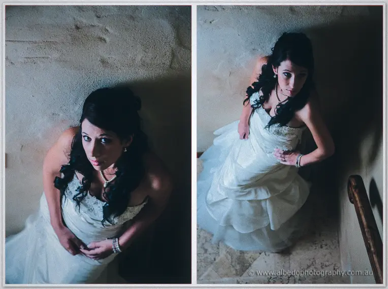 Diptych looking down on the bride in her layered gown as she gazes up beside a textured stone wall.
