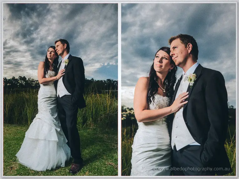 Dusk portrait of Sarah leaning against Daniel in the tall grass as storm clouds gather over Brookleigh.