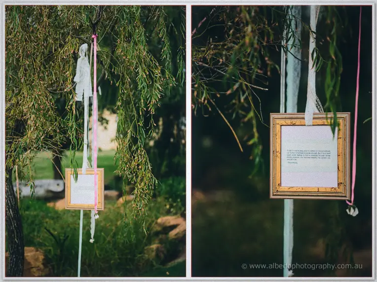 Gilt-framed love letter and lace ribbons hanging from a willow bough in the Brookleigh gardens.