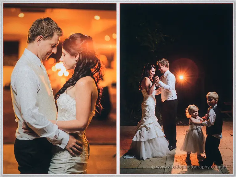 Sarah and Daniel sway cheek to cheek in warm lamplight as flower girl and page boy dance nearby.