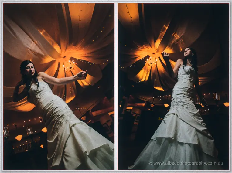 From a low angle, Sarah dances beneath a billowing canopy and glowing chandeliers.