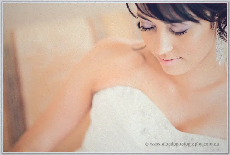 Close-up of Sarah looking down serenely in her beaded gown, crystal earring brushing her shoulder