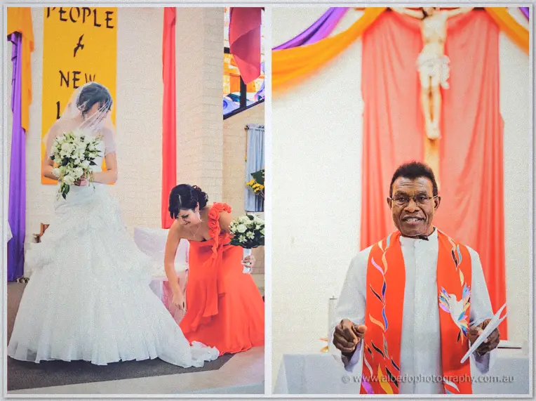 Bridesmaid kneeling to arrange Sarah's train on the altar steps beside the smiling robed priest