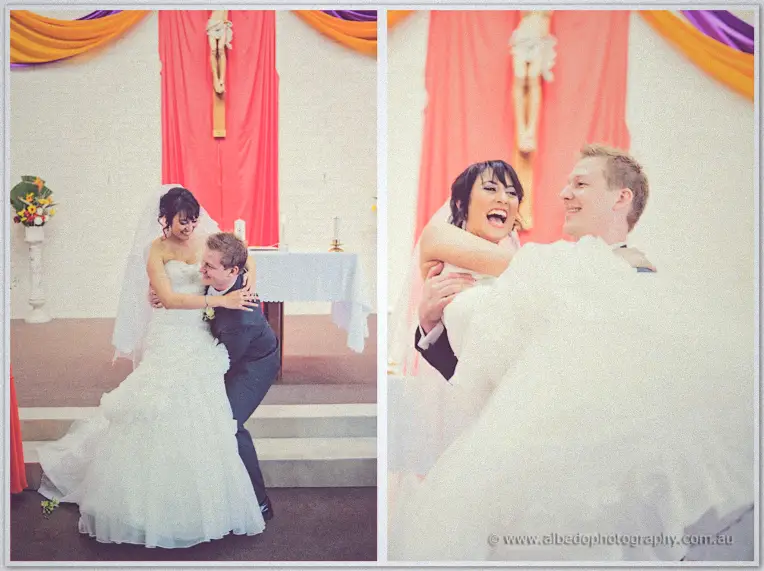 Shannon dipping Sarah into a laughing kiss at the altar beneath the crucifix after their vows