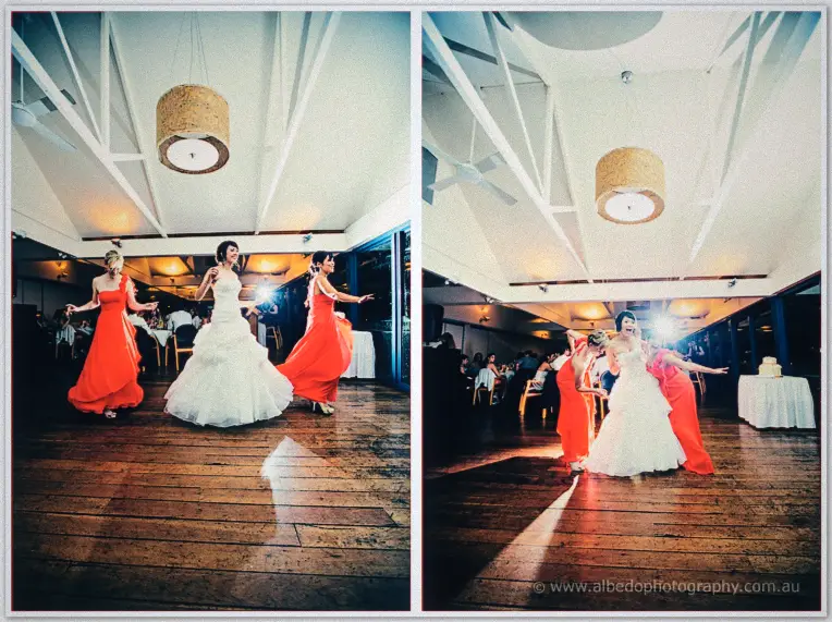 Sarah dances with her bridesmaids as they spin her into a curtsy on the timber floor