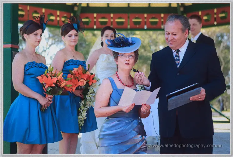 Celebrant reading from her notes while Felicity and Phil look on in the rotunda