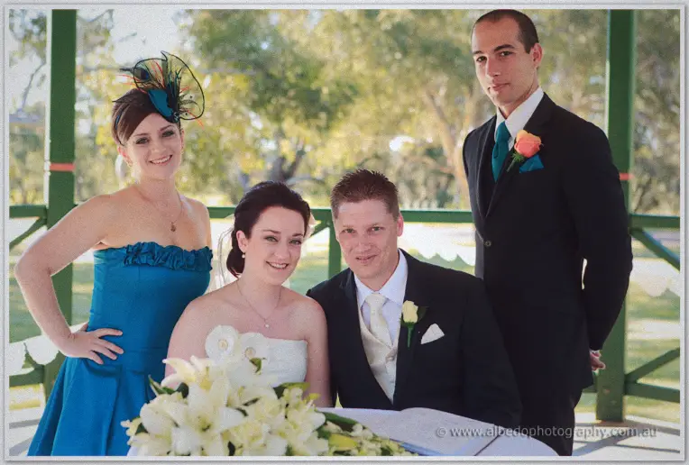 Felicity and Phil signing the register flanked by their witnesses
