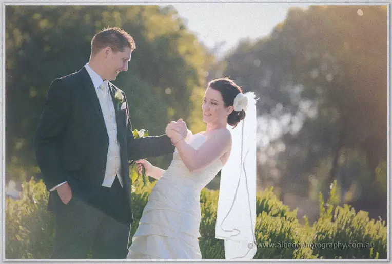 Phil dipping his bride Felicity playfully in the golden afternoon light