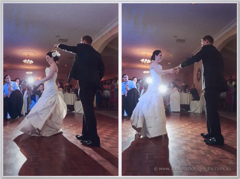 Phil twirls Felicity across the parquet dance floor beneath chandeliers as guests look on