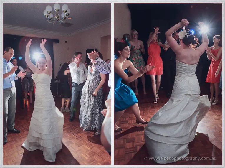 Felicity raises her arms dancing among clapping guests, then whirls so her skirt flares out