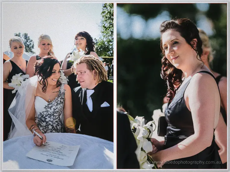 Jenna signs the marriage certificate at a white table while Andrew leans close and bridesmaids watch