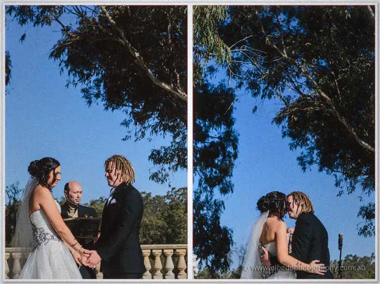 Jenna and Andrew hold hands before the celebrant, then kiss beneath a sprawling gum tree