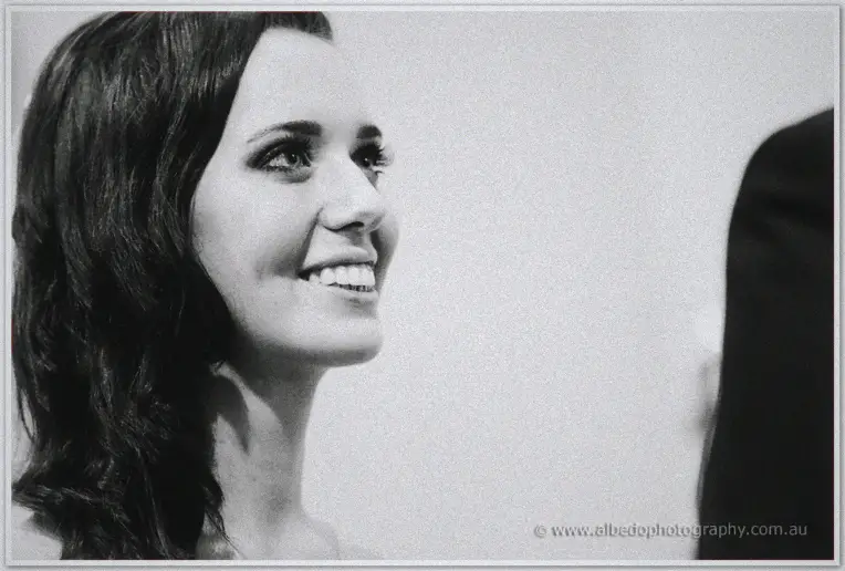Karis laughs through her vows in a grainy black and white close up
