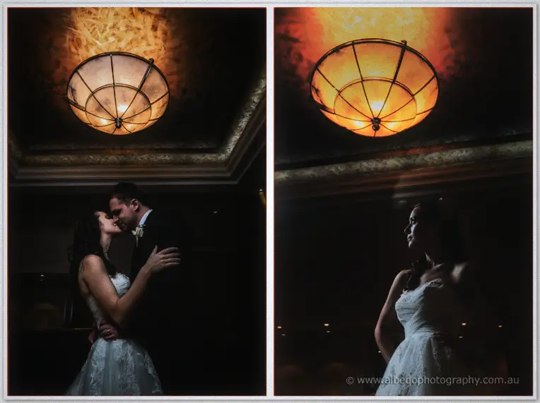 Beneath a glowing amber ceiling light, Karis kisses Nathan in shadow, then stands alone in profile