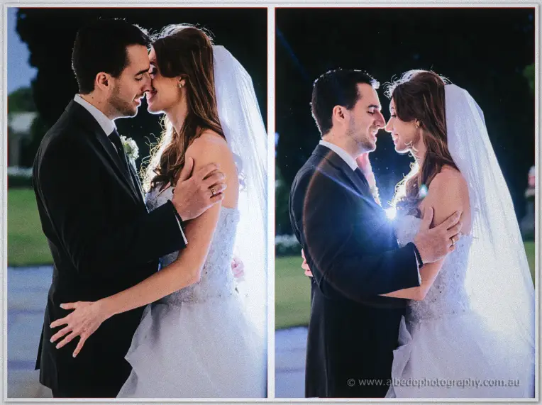 Michele and Nick embrace at dusk, backlight flaring between them on the quiet lawn.