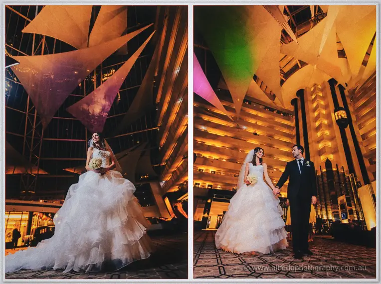 Michele and Nick walk hand in hand beneath the sails of the soaring hotel atrium.