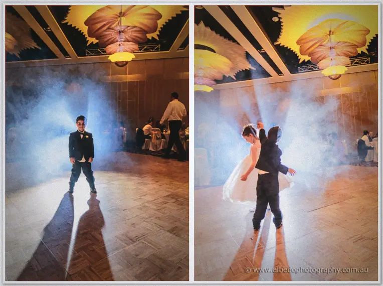 The page boy strikes a pose in dry-ice haze before spinning his flower girl on the dance floor.