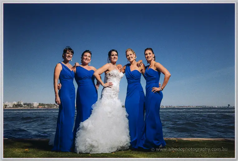 Allison flanked by four bridesmaids in royal blue gowns on the Swan River foreshore