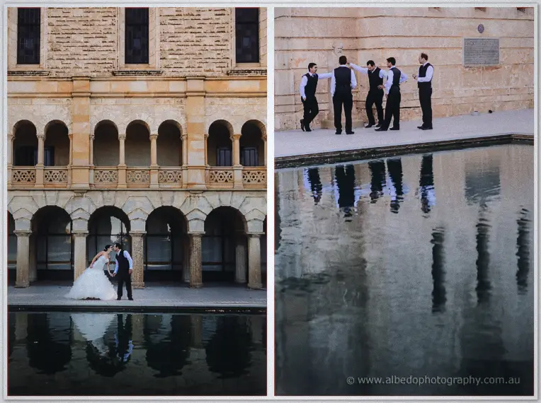 A kiss by the reflecting pool while groomsmen share a joke along the sandstone wall behind them.